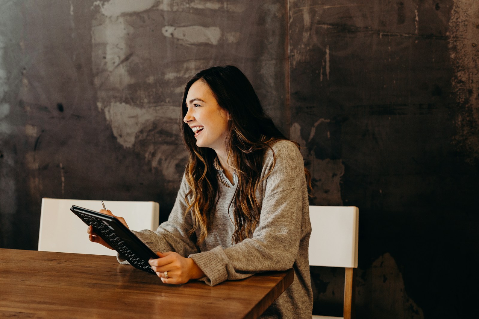 A business owner reviewing work at a table with a tablet