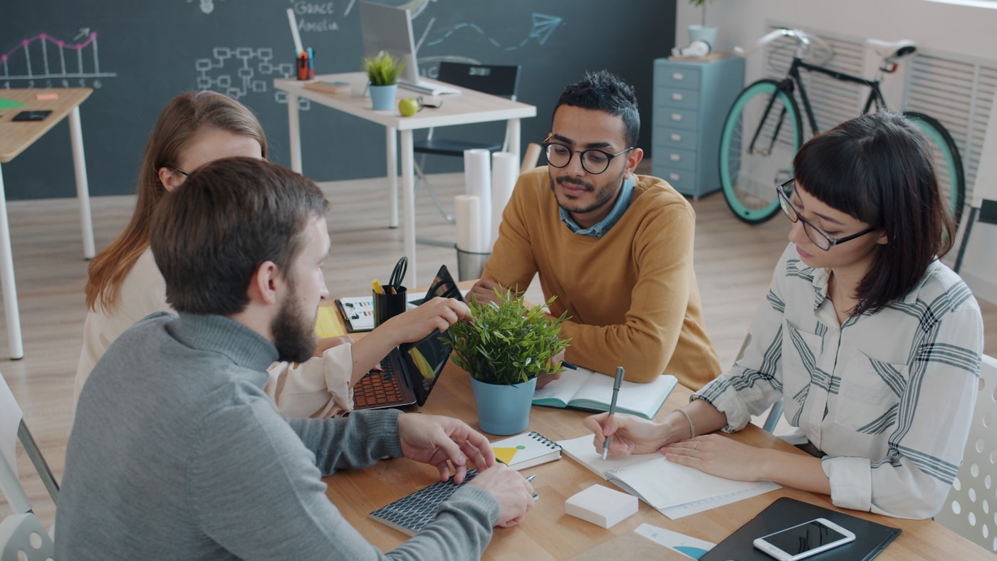 A team reviewing work together at a table